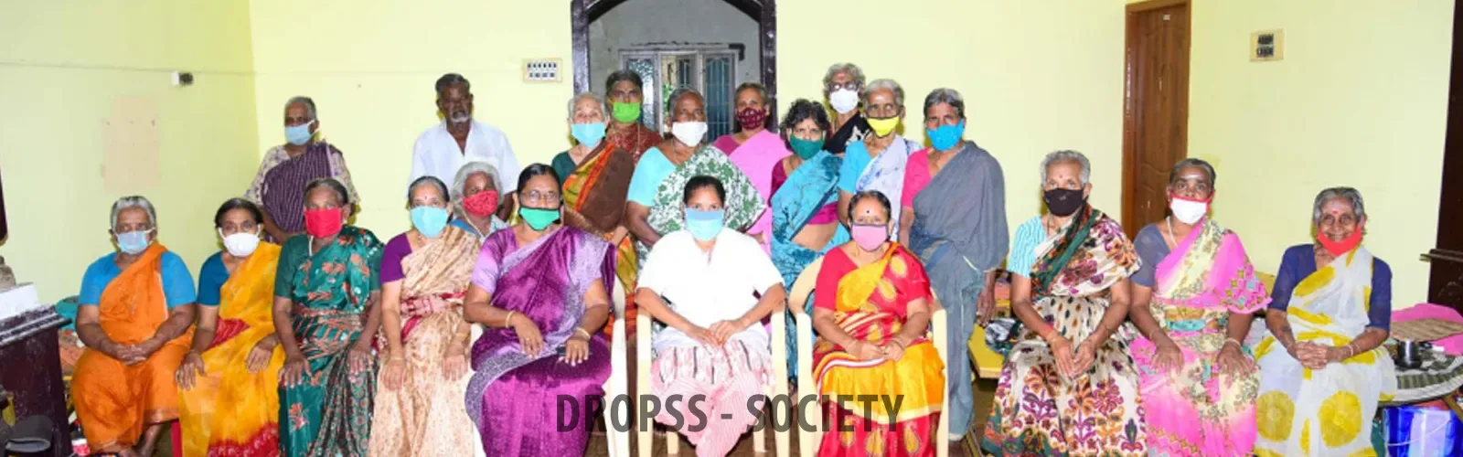 DROPSS residents and staff gathered with the society banner
