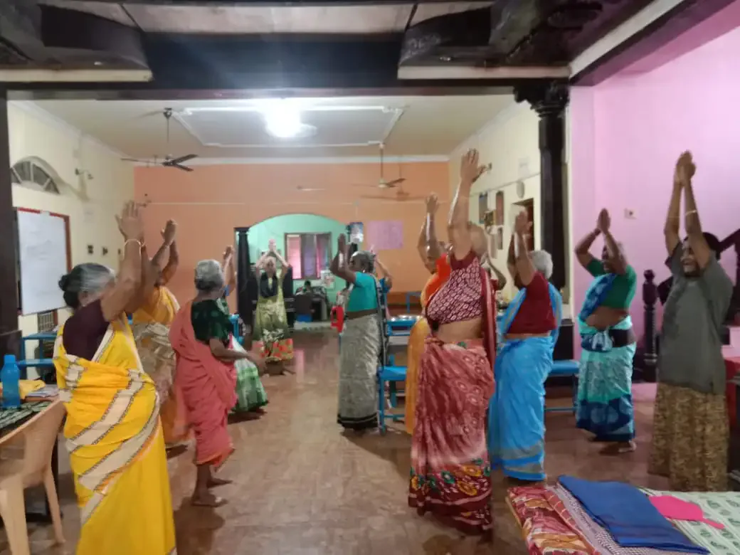 Elders practising yoga together at the home